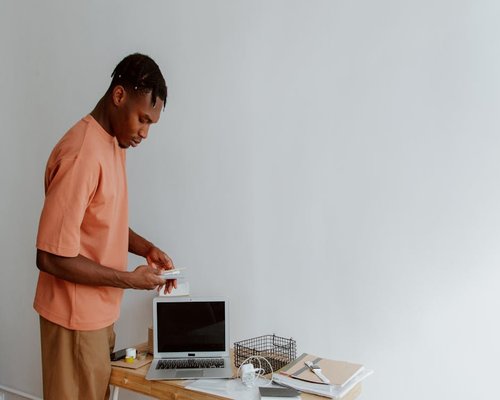 A focused person neatly closing their laptop on a modern home office desk setup