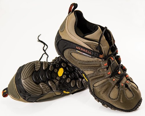A person ties the laces of practical, comfortable walking sneakers before going out